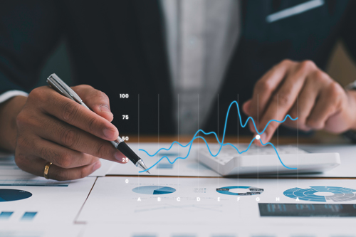A person viewing charts with various data