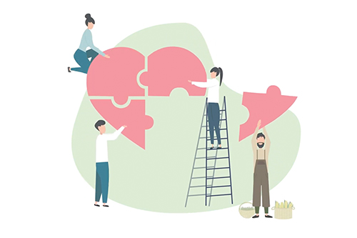 An illustration of four people stacking together a heart from puzzles